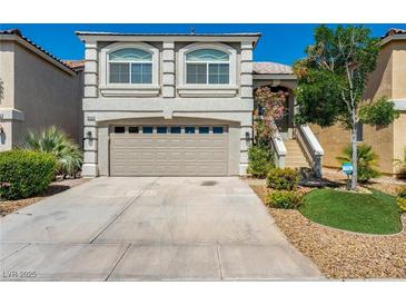 Two-story house with attached garage and landscaped front yard at 8449 Kettledrum St, Las Vegas, NV 89139