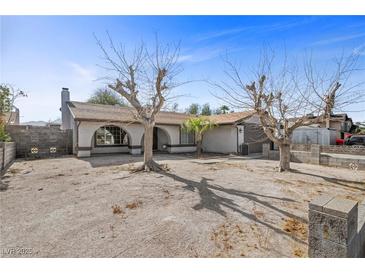 Charming single-story home with desert landscaping and mature trees in a residential neighborhood at 1841 Golden Shadow Dr, Henderson, NV 89002
