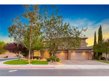 Charming two-story home featuring a three-car garage and well-manicured lawn, inviting curb appeal and a welcoming ambiance at 19 Desert Highlands Dr, Henderson, NV 89052