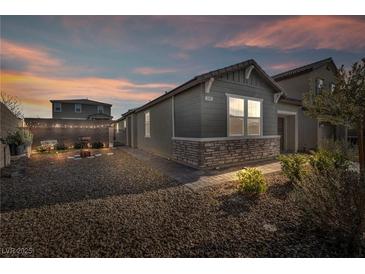 Charming single-story home featuring stone accents and a well-maintained yard with decorative string lights at 3491 Argiento Ave, Henderson, NV 89044