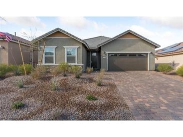 Charming single-story home featuring desert landscaping, a two-car garage, and a welcoming facade at 581 Bella Serenata Ct, Henderson, NV 89011