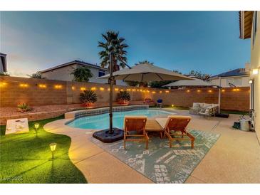 Inviting backyard pool with lounge chairs, string lights, and well-maintained landscaping, perfect for outdoor relaxation at 10899 Royal Highlands St, Las Vegas, NV 89141