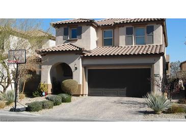 Charming two-story home with a two-car garage, brick paver driveway, and well-manicured landscaping at 10976 Bluebell Basin Rd, Las Vegas, NV 89179