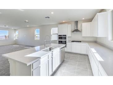 Bright, open kitchen features stainless steel appliances, large island, and modern finishes at 11576 Ashy Storm Ave, Las Vegas, NV 89138