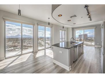 Bright, open kitchen with stainless steel appliances, a kitchen island, and stunning city views from the large windows at 200 W Sahara Ave # 2108, Las Vegas, NV 89102