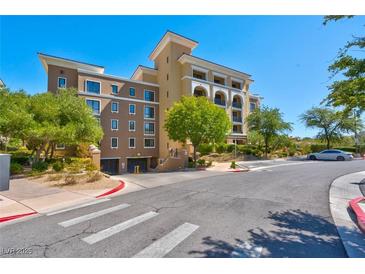 Attractive multi-story condo building with manicured landscaping and convenient garage access at 29 Montelago Blvd # 205, Henderson, NV 89011