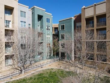 Attractive condo buildings with balconies surround a courtyard with trees and walkways at 50 E Serene Ave # 123, Las Vegas, NV 89123