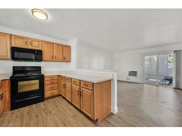 Bright kitchen features wooden cabinets, black appliances, and an open concept layout at 5394 Swenson St # 29, Las Vegas, NV 89119