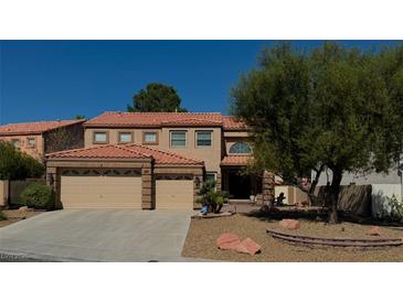 Charming two-story home with a red tile roof, three-car garage and landscaped front yard at 8404 Bay Crest Dr, Las Vegas, NV 89128