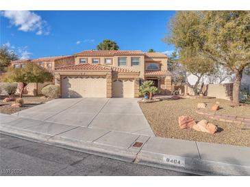 Charming two-story home featuring a tile roof, three-car garage, and desert landscaping at 8404 Bay Crest Dr, Las Vegas, NV 89128