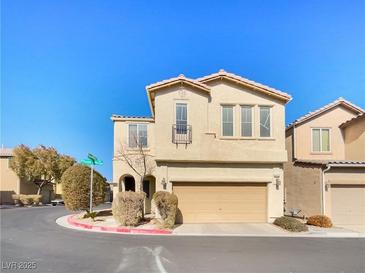 Charming two-story home with stucco exterior, two car garage, and desert landscaping at 8452 Viansa Loma Ave, Las Vegas, NV 89149