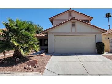 Charming two-story home featuring a low maintenance desert front yard with a two car garage and tile roof at 2451 Muirfield Ave, Henderson, NV 89074