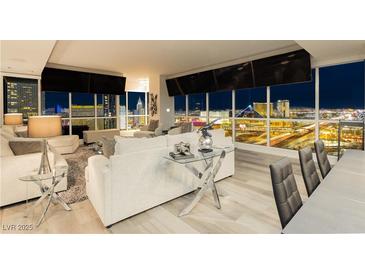 Modern living room with floor-to-ceiling windows showcasing city views and contemporary furnishings at 4575 Dean Martin Dr # 2400, Las Vegas, NV 89103