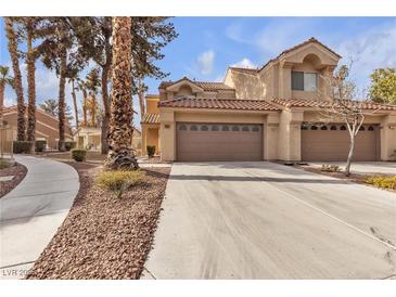 Charming townhome with attached garage and well-maintained landscaping at 5325 La Patera Ln, Las Vegas, NV 89149