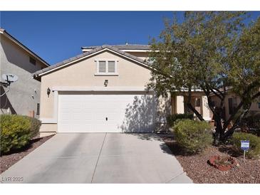 Beige single Gathering home with a two car garage and a concrete driveway and desert landscaping at 916 Echo Beach Ave, North Las Vegas, NV 89086