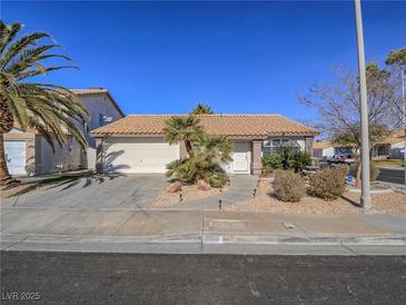 Charming single-story home with well-manicured desert landscaping and a two-car garage at 1402 Bareback Ct, Henderson, NV 89014