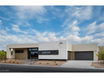 Contemporary one-story home with desert landscaping, a dark grey garage door and blue skies at 3430 Cosima Ln, Las Vegas, NV 89120