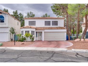 Charming two-story home featuring a neutral stucco facade, red tile roof, and meticulously maintained front yard with ample parking at 3491 Bankside Dr, Las Vegas, NV 89129