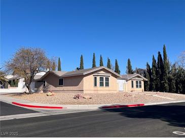 Charming single-story home featuring mature landscaping, a neutral color palette, and a well-maintained yard at 798 Shirley Ln, Boulder City, NV 89005