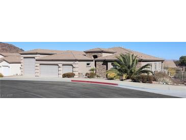 Spacious home featuring a tile roof, desert landscaping, and a three-car garage at 814 Lake Hill Dr, Boulder City, NV 89005