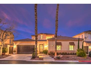 Charming home featuring desert landscaping, covered windows, and a two car garage at 11342 Winter Cottage Pl, Las Vegas, NV 89135