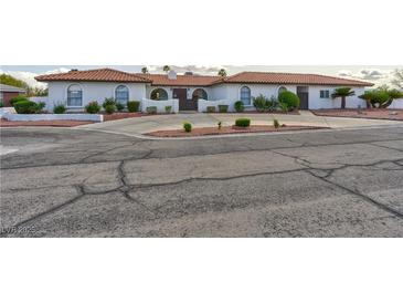 Charming home featuring stucco exterior, tile roof, and low-maintenance desert landscaping at 1780 Westwind Rd, Las Vegas, NV 89146