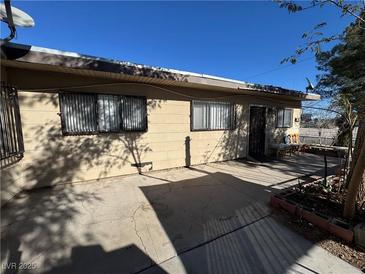 Cozy backyard patio featuring a concrete floor, desert landscaping, and comfortable seating area at 2043 Donna St, North Las Vegas, NV 89030
