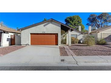 Charming single-story home featuring a red garage door and low-maintenance landscaping at 4768 W Montara Cir, Las Vegas, NV 89121
