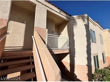 The exterior of this multi-Gathering building features a staircase leading to the units, a balcony, and well-maintained landscaping at 5000 Red Rock St # 228, Las Vegas, NV 89118