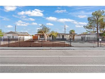 Charming single-story home with a meticulously landscaped front yard and black metal fence at 5168 Wilbur St, Las Vegas, NV 89119