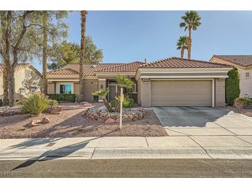 Charming single-story home with a well-maintained front yard and attached two-car garage at 9145 Villa Ridge Dr, Las Vegas, NV 89134