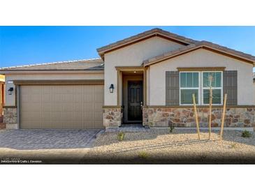 Inviting single-story home featuring stone accents, a two-car garage, and a covered entryway at 325 S Orleans St # Lot 3, Henderson, NV 89015