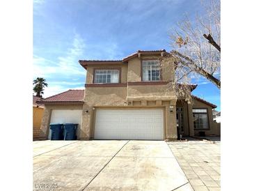 Two-story home with three-car garage and desert landscaping at 5255 Autumn Sky Rd, Las Vegas, NV 89118