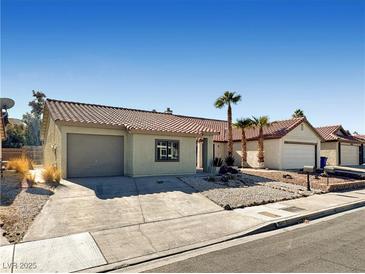 Charming single-story home with a well-maintained front yard and a two-car garage at 592 Grimsby Ave, Henderson, NV 89014