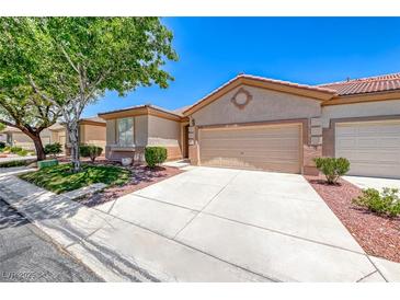 Charming single-story home showcasing a well-manicured front yard and a two car garage at 5952 Long Bay St, Las Vegas, NV 89148