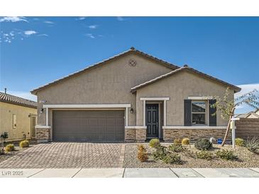 Charming single-story home featuring desert landscaping and a two-car garage at 6033 Bugsy St, North Las Vegas, NV 89081