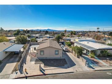 Charming single-story home with a well-maintained front yard and long driveway in a quiet neighborhood with mountain views at 104 Sir George Dr, Las Vegas, NV 89110