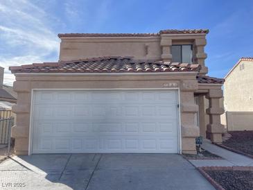 Charming two-story home showcasing a two-car garage and desert landscaping at 1331 Ebbetts Pass, Las Vegas, NV 89110