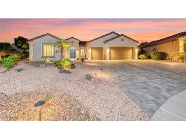 Stunning single-story home featuring desert landscaping, tiled roof, and a spacious three-car garage at 2239 Discovery Lake Ct, Henderson, NV 89044