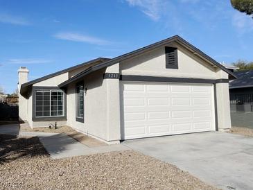 Charming single-story home featuring a two-car garage and low maintenance desert landscaping at 4240 Caliper Dr, Las Vegas, NV 89110