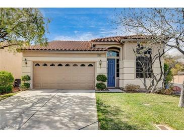 Charming single-story home featuring a well-manicured lawn and a classic two-car garage with traditional design elements at 5965 Poplar Tree St, Las Vegas, NV 89148