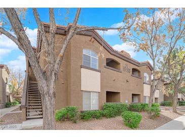 Condo exterior with brown stucco, tile roof, second story entrances and mature trees at 9000 Las Vegas Blvd # 2138, Las Vegas, NV 89123