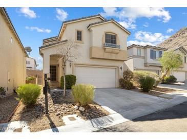 Inviting two-story home featuring a neutral palette, attached garage and low maintenance front yard at 10651 Streamside Ave, Las Vegas, NV 89129