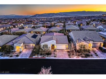 A street view of charming single-Gathering homes featuring desert landscaping and mountain views at 11831 Saverio Ave, Las Vegas, NV 89138