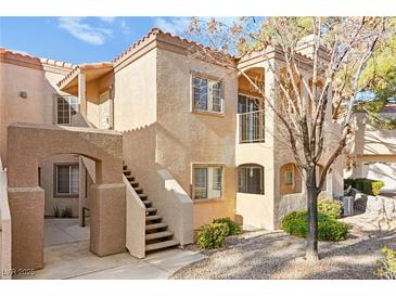 Charming multi-level home with stucco exterior, private balcony, and well-maintained landscaping at 1851 Hillpointe Rd # 2922, Henderson, NV 89074