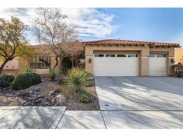 Charming single-story home features a tile roof, desert landscaping, and a three-car garage at 2329 Quartz Peak St, Las Vegas, NV 89134