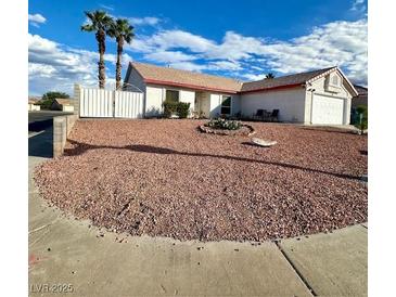 Charming single-story home featuring a low maintenance xeriscaped front yard and white fencing at 470 Como Ct, Henderson, NV 89015