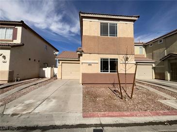 Two-story home featuring a two-car garage and a well-maintained front yard at 5212 Paradise Skies Ave, Las Vegas, NV 89156