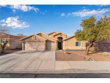 Charming single-story home with a three-car garage, desert landscaping, and a well-maintained lawn at 58 Desert Sunflower Cir, Henderson, NV 89002