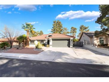 Charming single-story home with desert landscaping, tile roof and a two car garage at 60 Reyburn Dr, Henderson, NV 89074